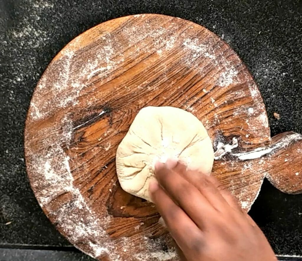 Press the dough in the middle gently and again spread some wheat flour